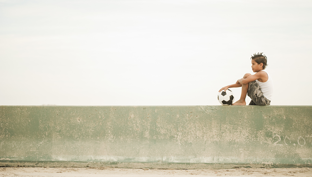 a boy sitting alone